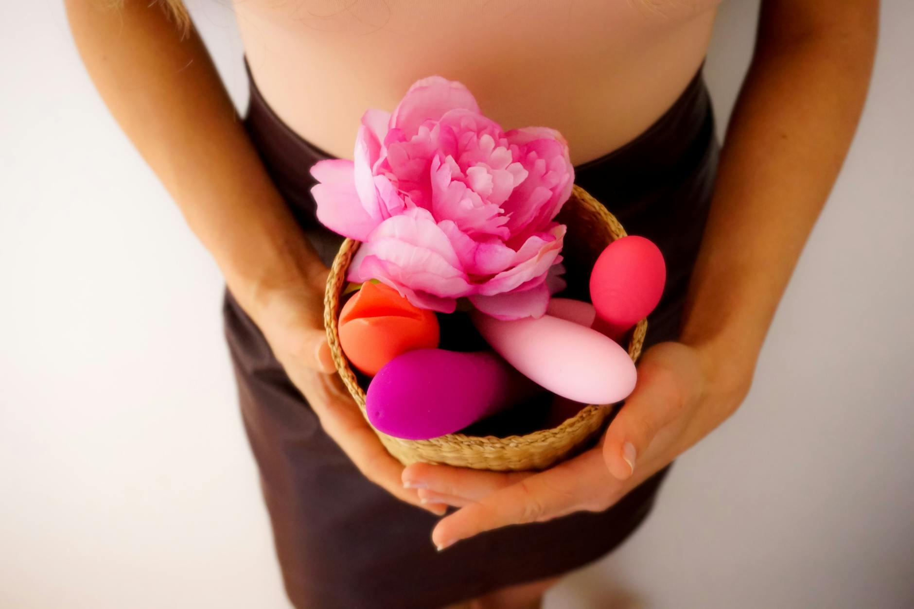 Woman holding silicone vibrators, exploring pleasure after recovery