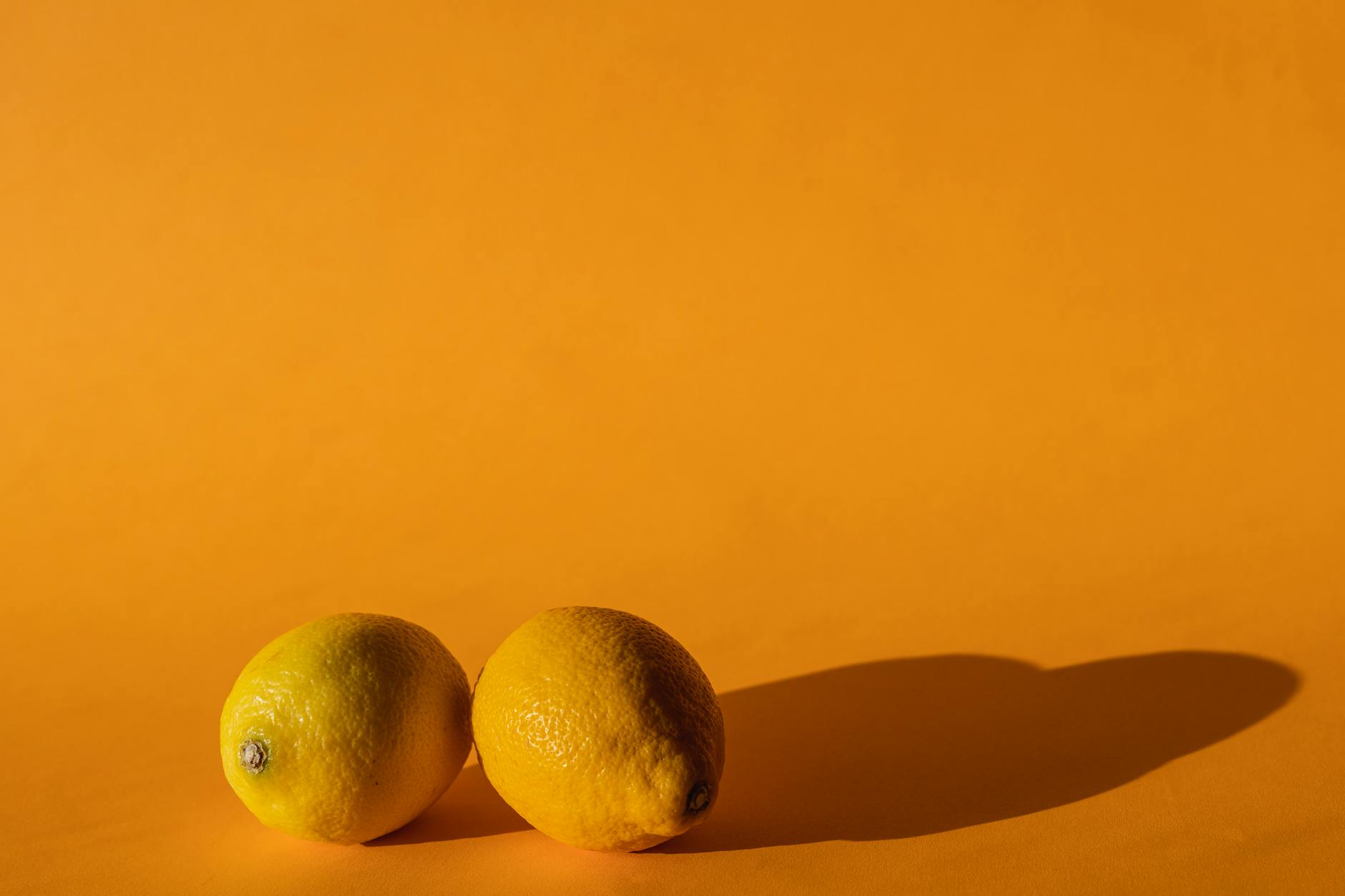 Bright fresh lemons on a yellow background symbolizing new beginnings and renewal